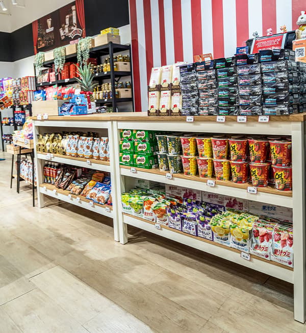 TORNVIKEN kitchen islands filled with products are placed against a red and white striped wall.