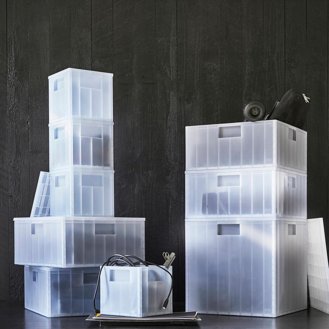 Translucent blue PANSARTAX storage boxes stacked together with various sizes and lids.
