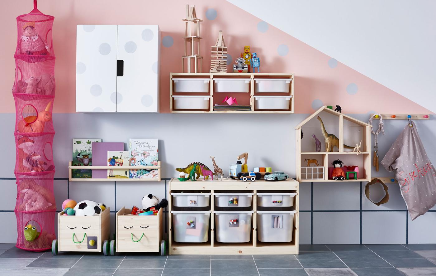 TROFAST storage combinations along with cabinets, shelves, and boxes that organise the toys in this children’s room.