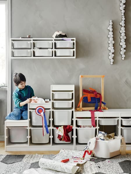 TROFAST storage system with child playing. 