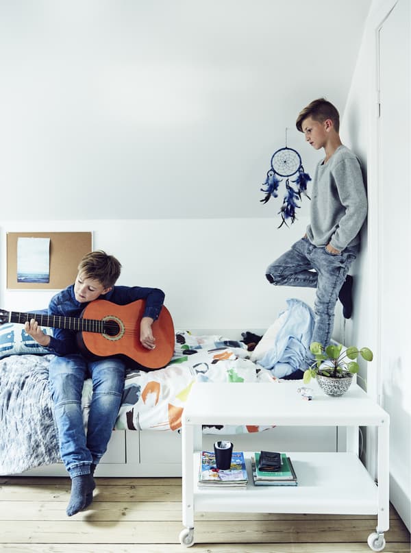 Two boys playing in a child’s bedroom.