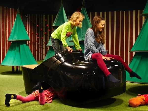 Two children got on big shoes.