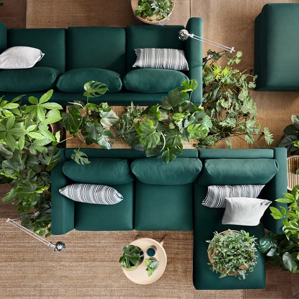 Two dark green IKEA VIMLE three-seater sofa sectionals, that are modular and come with removable sofa covers to change style.