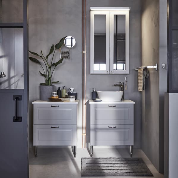 Two IKEA GODMORGON grey bathroom cabinets, each with two deep bathroom drawers and chrome-plated handles.