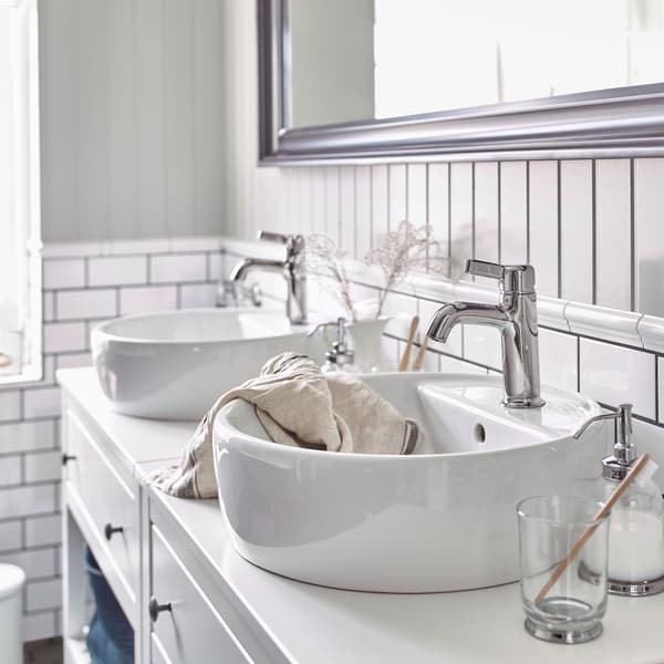 Two IKEA HEMNES white open wash-stands, IKEA TÖRNVIKEN ceramic wash-basins, and VOXNAN chrome-plated wash-basin mixer taps.