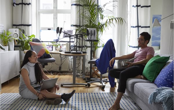 Two people in a studio bedroom.
