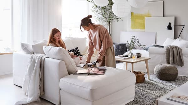 Two people looking at catalogues and planning a home furnishing project.