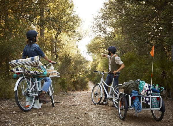 Two people out for a bike ride on a woodland path.