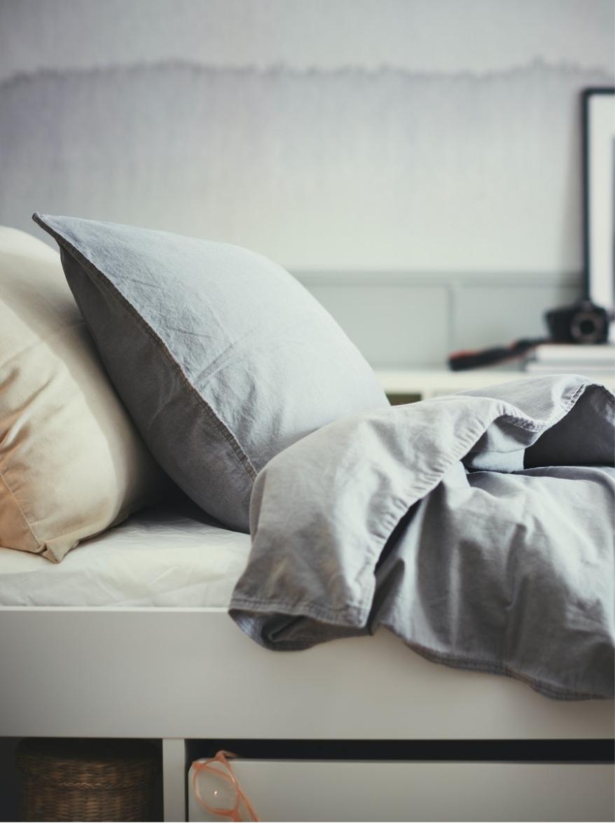 Two pillows and a blanket shown on a bed.