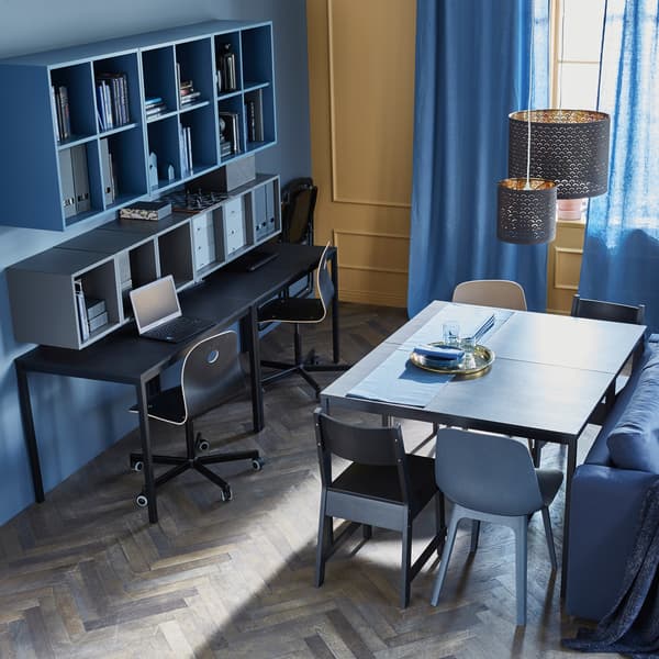 Two tables are placed together to create an everyday dining table, while two others sit against a wall as a workspace.