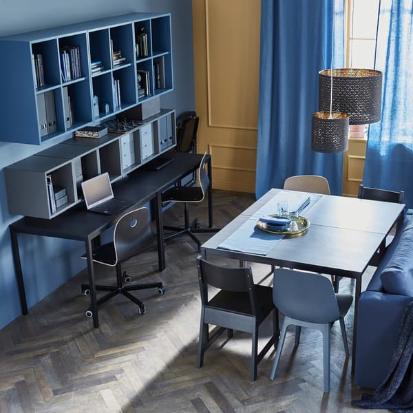 Two tables placed together create an everyday dining table, while two other tables create a workspace against a wall.