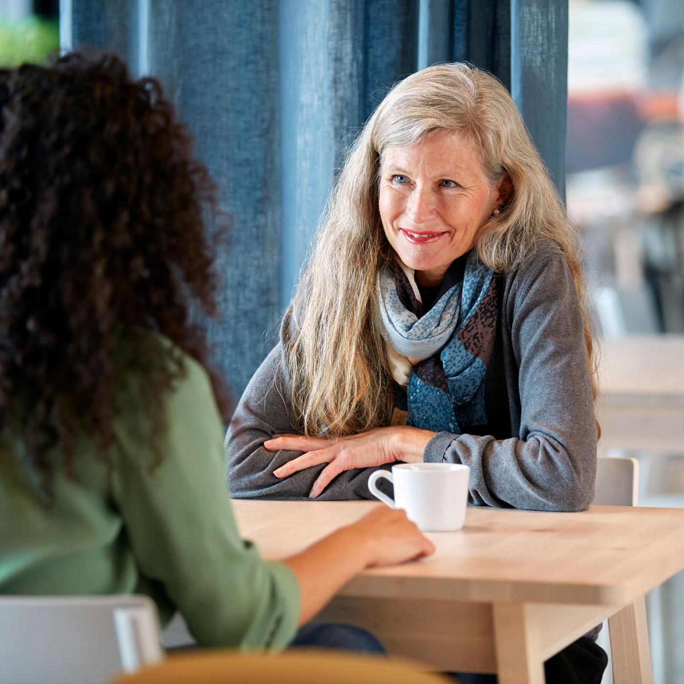 Two women talking at a table
