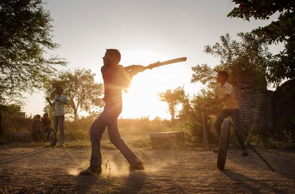 Two young people playing baseball. Developing teamwork skills is one of the themes of the IKEA Let’s Play campaign.