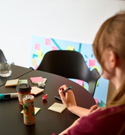 Un employé FunPlus écrit sur des notes autocollantes en papier.