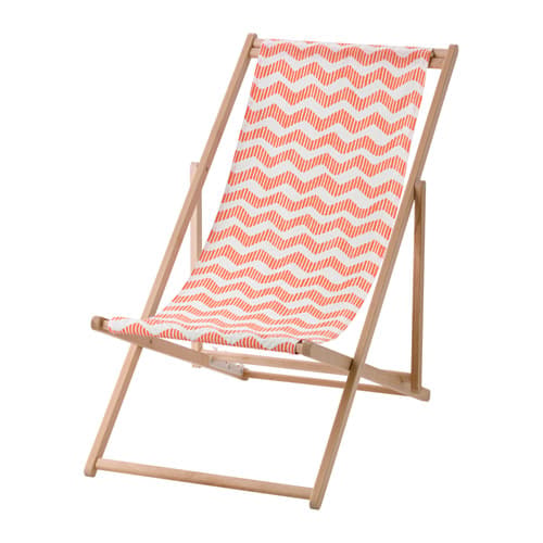 Una silla de playa plegable en madera con un asiento de tela estampada en rojo y blanco.