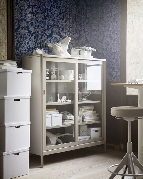 Une armoire de bureau en métal beige avec des portes en verre