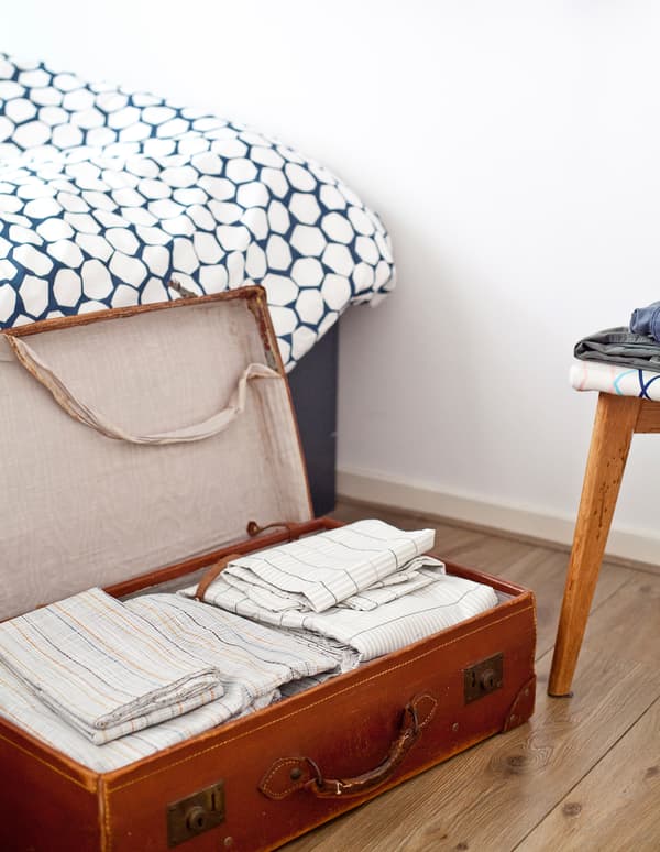 Upcycle idea: Store bed linen in a suitcase.