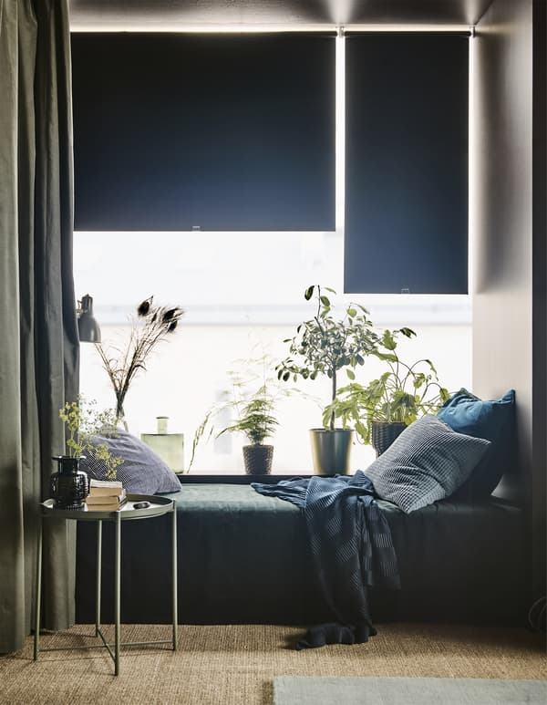 Update your living room with modern furniture from IKEA. A bed such as SKOTTERUD wooden base sprung mattress in dark grey fits in a little nook for overnight guests. When the bed is not being used, it makes a good place to sit down and take a breather.