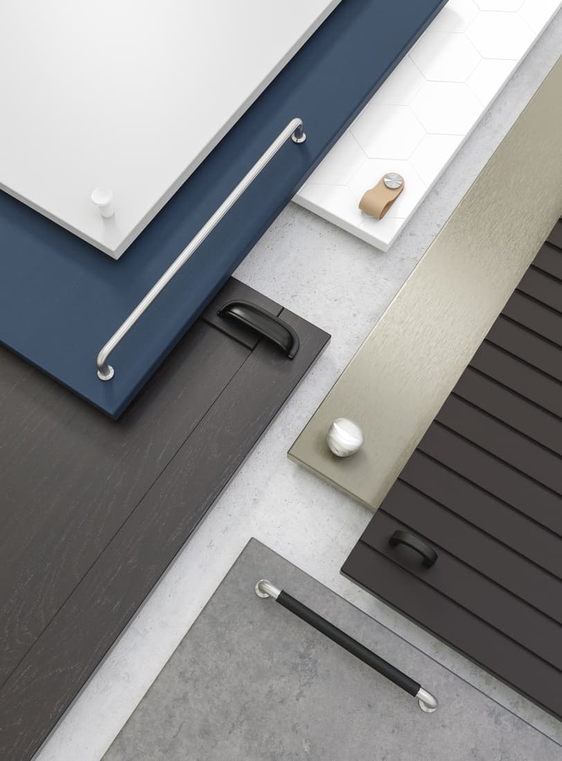 Various knobs and handles on different coloured door fronts. 