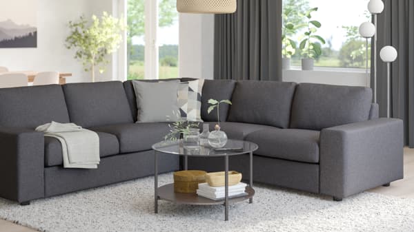 VIMLE modular sofa in grey in a cozy living room setting, decorated with soft lighting, round coffee table, and a white rug.