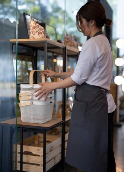 Waitress tyiding up a shelf
