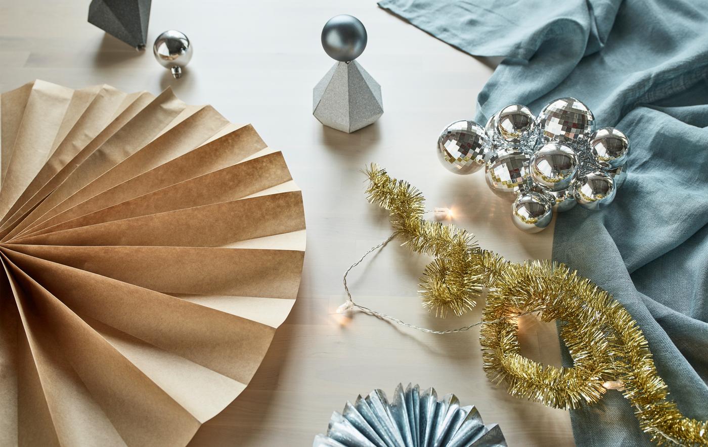 Wall decor, table toppers and paper rosettes recycled from party decorations like silver gift boxes, baubles and wrapping paper.