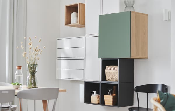 Wall section with EKET shelving units combined with other storage units, creating a deliberately irregular yet geometric look.