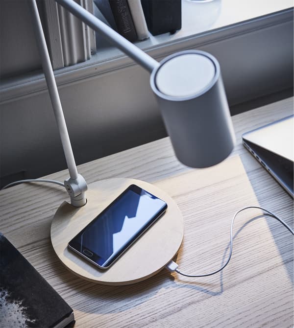 Want a work lamp that blends in with your living room and also fits your home office? Try IKEA RIGGAD; a work lamp and wireless charger in one. The wood and soft design give it a look that’s different to most technical products.