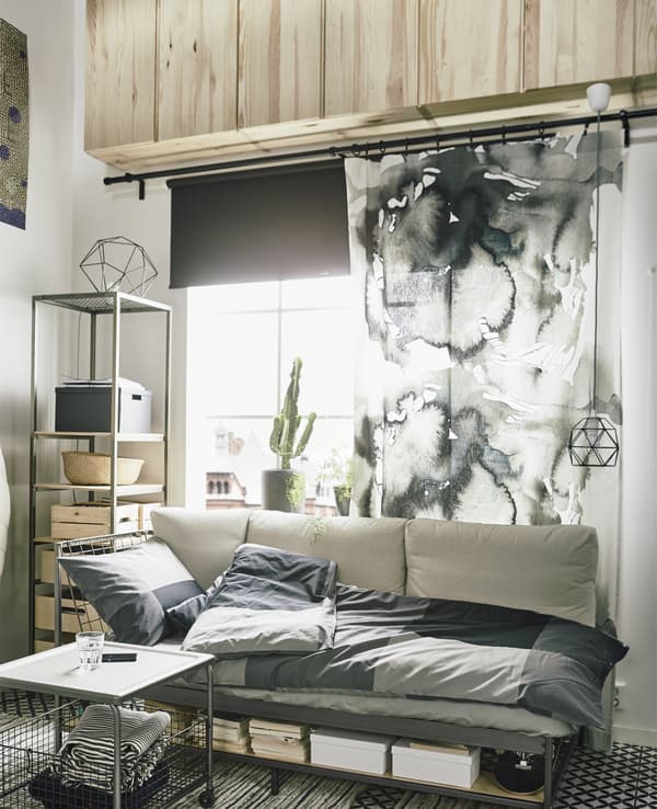 Want small space furniture ideas? IKEA has a wide range of small apartment furniture. Here we used the room’s height to free up floor space. Use a row of IVAR cabinets to store things you don’t need daily. Reach the cabinets with an easy-to-move ladder.