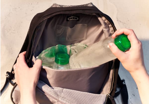 Water bottles are unpacked from a backpack.