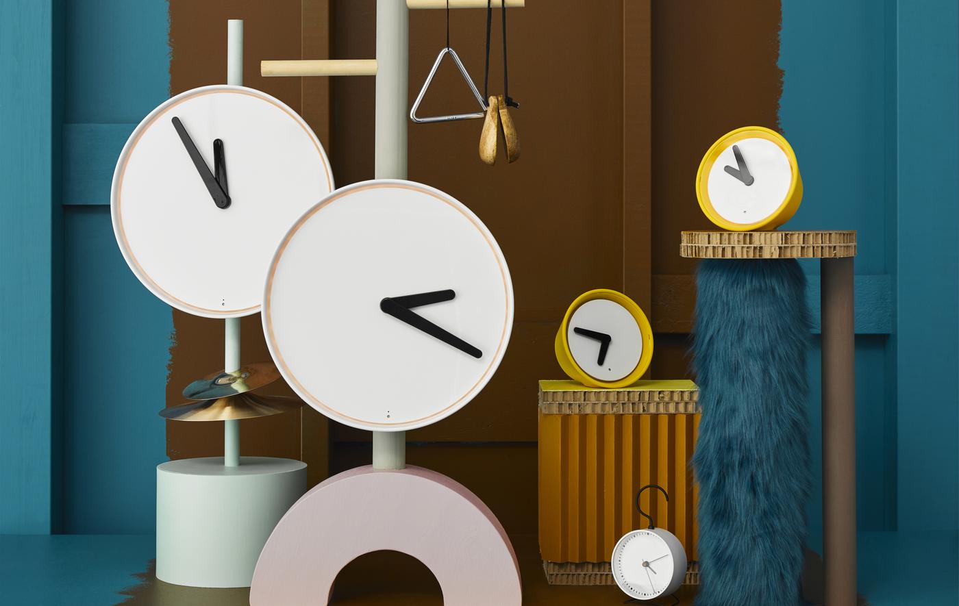 White and yellow clocks of different sizes.