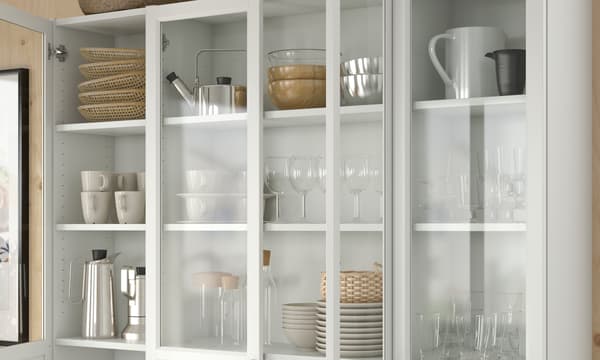 White BILLY bookcases in the dining room area with cutleries and bowls. 