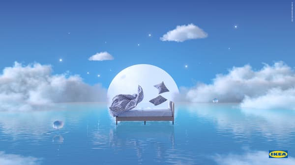 White/dark blue, leopard print KVASTFIBBLA bedding lifts above a SLATTUM bed, floating on blue water against a rising moon.