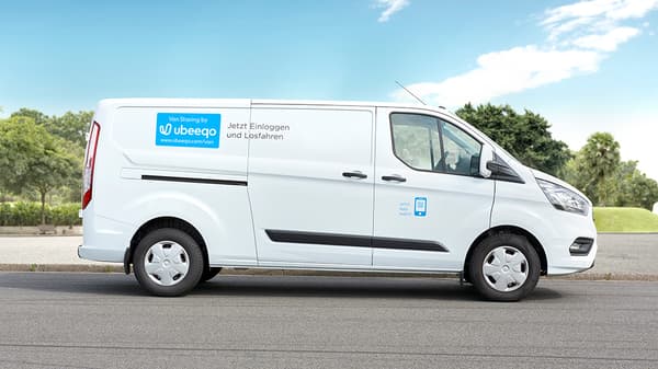 White delivery van with Ubeeqo car sharing branding parked on the side of the road, promoting IKEA transport service.