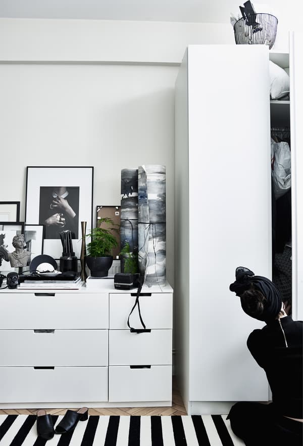 White IKEA storage furniture in a bedroom.