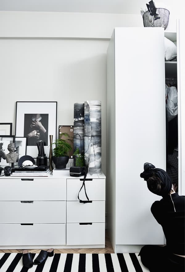 White IKEA storage furniture in a bedroom.