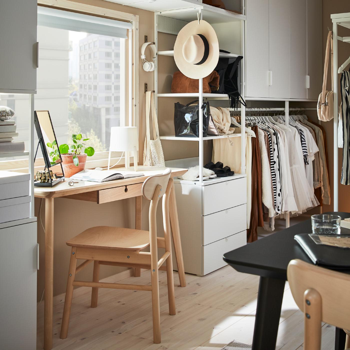 White, PLATSA storage combination with stationery and clothes, around a birch LISABO desk and RÖNNINGE chair.