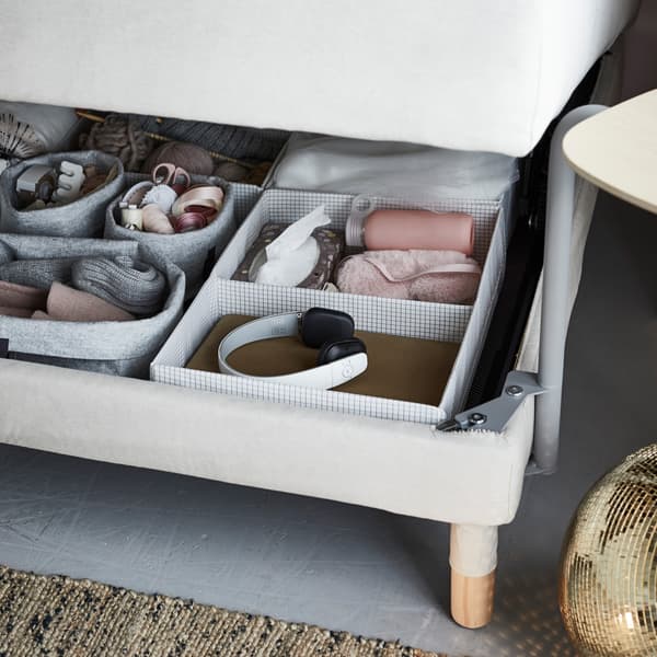 With a multifunctional sofa bed, you can use IKEA STUK storage cases to keep everything you want to have close by. Think knitting supplies, headphones, and eye masks.
