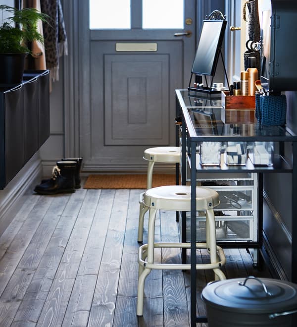With the help of a narrow table, two stools, some organisers, trolleys and a lighted mirror you can make a hair and makeup station.