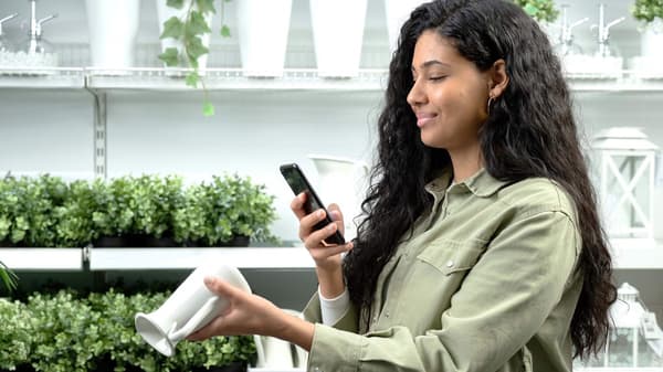 Woman scanning a vase with her phone
