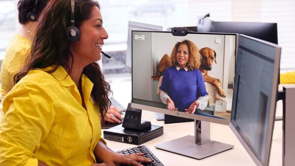 woman sitting at computer with headphones on