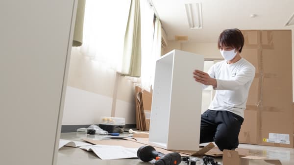棚を組み立てる人。