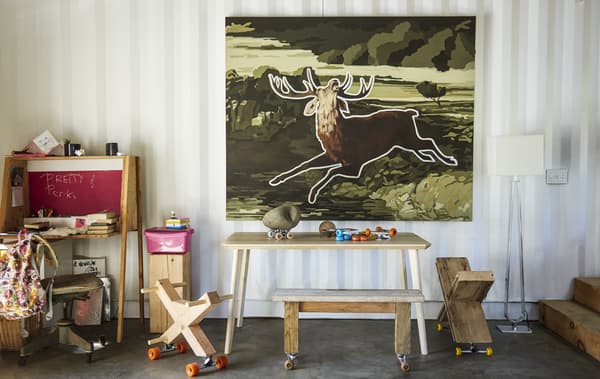 Wooden sculptures on castors and a desk.