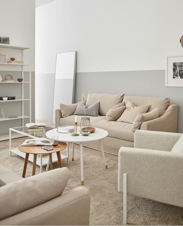 Woods, creamy white, and glass create a relaxing and organic feeling living room.