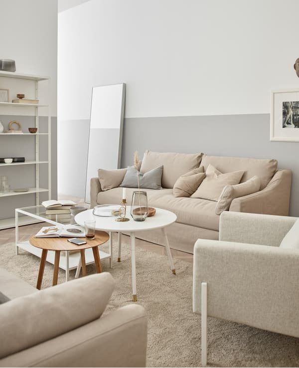 Woods, creamy white, and glass create a relaxing and organic feeling living room.