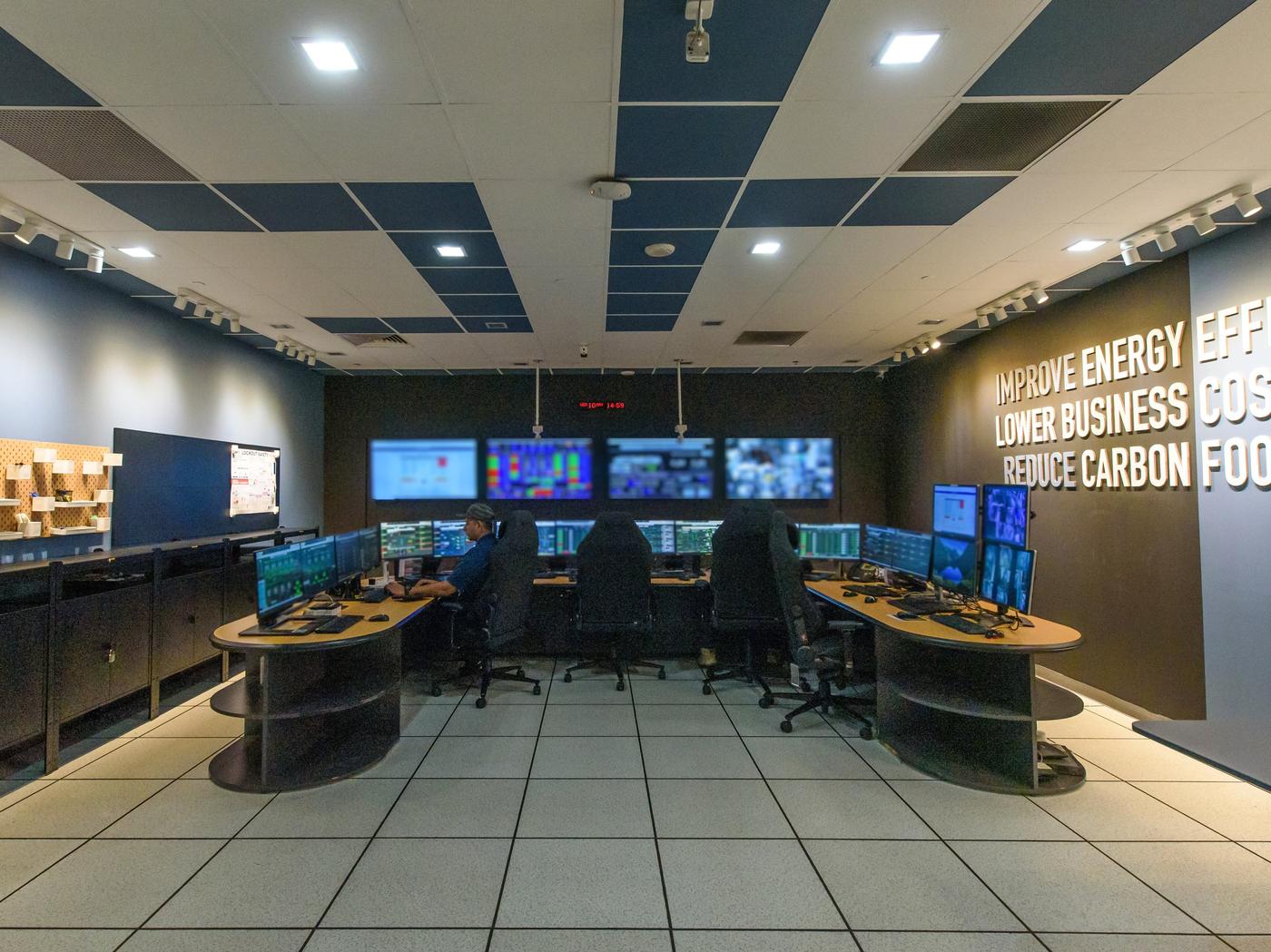 Workers working in front of monitors in an innovative control centre dedicated to sustainability.