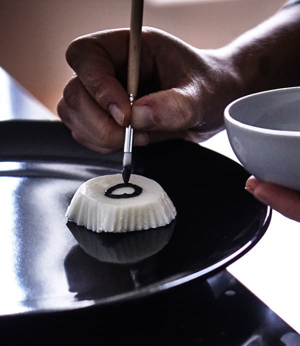 Yogurt that has bee frozen in IKEA DRÖMMAR baking cups are popped out and painted with edible paints.