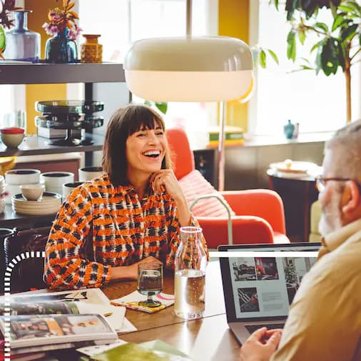 You see a smiling woman in a co-working space.