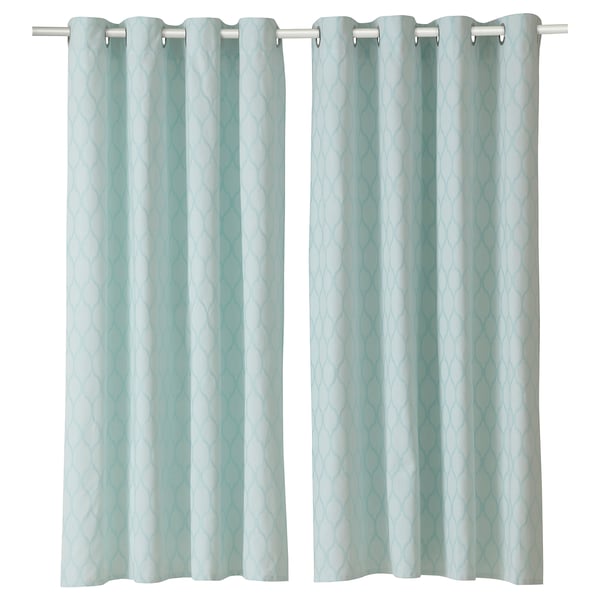 Two light blue curtains with a medallion pattern hang side by side. They have a silver rod and grommet design.