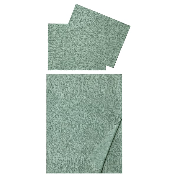 Two green, dotted, rectangular fabric sheets, one folded, one unfolded, soft and cool to touch, made of cotton and lyocell.